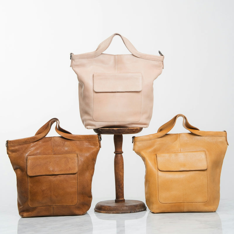 Three leather tote bags in different colors
